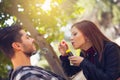 Couple Relaxing in the Park with bubble blower. Spring time. Royalty Free Stock Photo