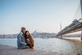 couple relaxing on the side of bosphorus during sunset Royalty Free Stock Photo