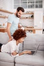 Couple Relaxing On Sofa At Home Looking At Laptop Together Royalty Free Stock Photo