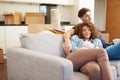 Couple Relaxing On Sofa With Hot Drink In New Home Royalty Free Stock Photo