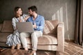 Couple relaxing on sofa with laptop. Love, happiness, people and