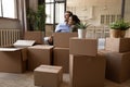 Couple relaxing on sofa near boxes with belongings on relocation Royalty Free Stock Photo