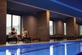 Couple relaxing in spa center by the swimming pool Royalty Free Stock Photo