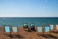 A couple relaxing on the striped chairs in Brighton beach Royalty Free Stock Photo