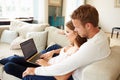 Couple Relaxing Using Laptop Computer For Internet Banking Royalty Free Stock Photo