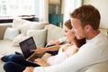 Couple Relaxing Using Laptop Computer For Internet Banking Royalty Free Stock Photo