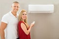 Couple with remote control air conditioner