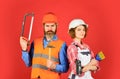 Couple is renovating home. couple doing apartment repair together themselves. man and woman wear safety helmet. couple Royalty Free Stock Photo