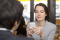 Couple in restaurant breakfasted, woman is on the phone, sms, surfing web