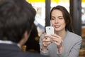 Couple in restaurant breakfasted, woman is on the phone, sms, surfing web