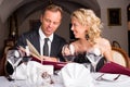 Couple at restaurant choosing what to eat from menu