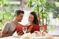 Couple, restaurant and reading a menu on date, fine dining and bonding on valentines day. People, love and romance at