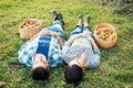 Couple resting on the grass in autumn after picking apples Royalty Free Stock Photo