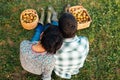 Couple resting on the grass in autumn after picking apples Royalty Free Stock Photo