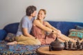 Couple resting at home. Aromatherapy Concept. Wooden Electric Ultrasonic Essential Oil Aroma Diffuser and Humidifier