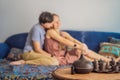 Couple resting at home. Aromatherapy Concept. Wooden Electric Ultrasonic Essential Oil Aroma Diffuser and Humidifier