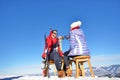 A couple is resting on lounges in picnic zone on european ski resort