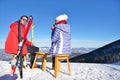 A couple is resting on lounges in picnic zone on european ski resort