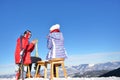 A couple is resting on lounges in picnic zone on european ski resort