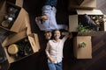 Couple resting on relocation day, lying on floor near boxes Royalty Free Stock Photo