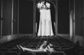 Couple rests on the chairs in an old hall with a big window Royalty Free Stock Photo