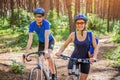 Couple riding a bicycle in the forest Royalty Free Stock Photo