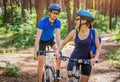Couple riding a bicycle in the forest Royalty Free Stock Photo