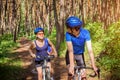 Couple riding a bicycle in the forest Royalty Free Stock Photo