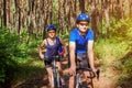 Couple riding a bicycle in the forest Royalty Free Stock Photo