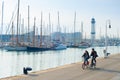 Couple riding bicycles, Barcelona marina