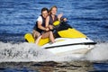 Couple riding jet ski