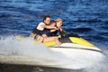 Couple riding jet ski