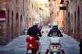 Couple riding motor scooter on city.Bikers on the road Royalty Free Stock Photo