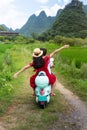 Couple riding motorbike around rice fields of Yangshuo, China Royalty Free Stock Photo