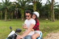 Couple Riding Motorbike, Young Man And Woman Using Cell Smart Phone Travel On Bike On Tropical Forest Road Royalty Free Stock Photo