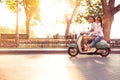 Couple riding a scooter and having fun Royalty Free Stock Photo