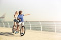 Couple riding on tandem bicycle outdoors Royalty Free Stock Photo