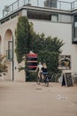 Couple riding a tandem bike through Oxford Castle Quarter, Oxford, UK