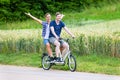 Couple riding tandem bike together in the country