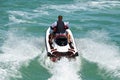 Couple riding Tandem on a Speeding Jet Ski.