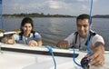 Couple Rigging Sails on Sailboat - Horizontal Royalty Free Stock Photo