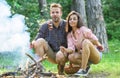 Couple roasting sausages on sticks nature background. Couple in love enjoy camping forest roasting sausage at bonfire Royalty Free Stock Photo