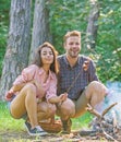 Couple roasting sausages on sticks nature background. Couple in love enjoy camping forest roasting sausage at bonfire Royalty Free Stock Photo