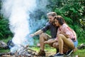 Couple roasting sausages on sticks nature background. Traditional roasted food as attribute of picnic. Camping and Royalty Free Stock Photo