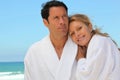 Couple in robes at the beach Royalty Free Stock Photo