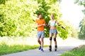 Couple with roller skates riding in summer park Royalty Free Stock Photo