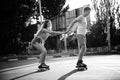 A couple roller-skating at sunset. Black and white Royalty Free Stock Photo