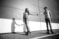 A couple roller-skating at sunset. Black and white photo Royalty Free Stock Photo