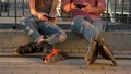 Couple on rollerblades sitting.