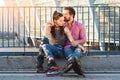 Couple on rollerblades sitting. Royalty Free Stock Photo